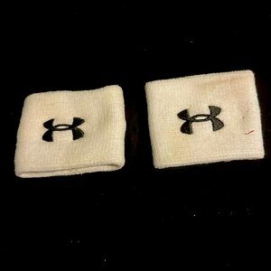 Two white Under Armour wristbands.